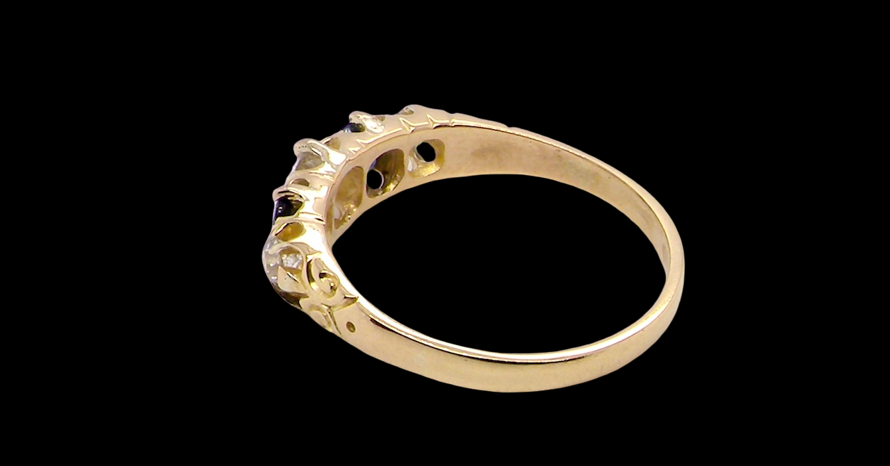 rear An antique ring from the early years of the 20th century. Centre stone 5mm diameter (0.50 carats) Colour H-j, clarity Si. Each side a mid colour blue sapphire 4mm diameter.
