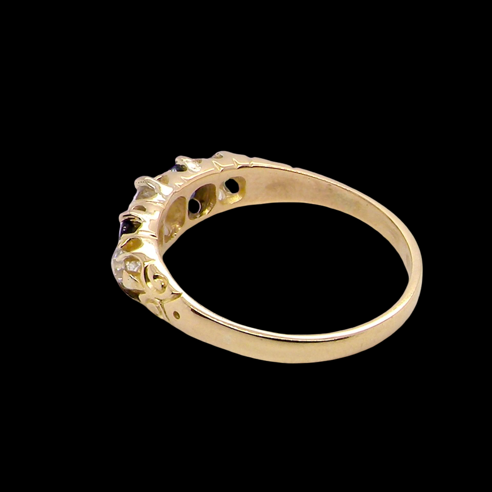 rear An antique ring from the early years of the 20th century. Centre stone 5mm diameter (0.50 carats) Colour H-j, clarity Si. Each side a mid colour blue sapphire 4mm diameter.