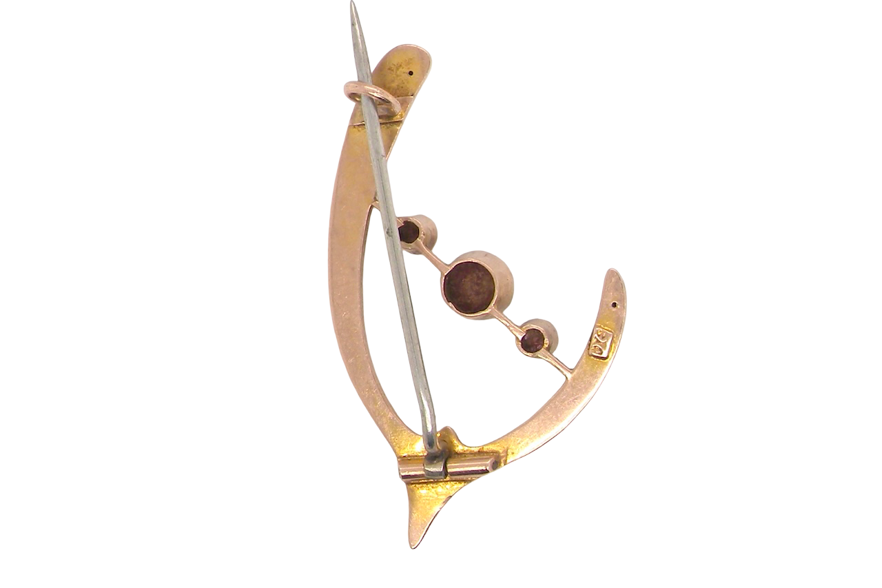 An antique wishbone shaped brooch