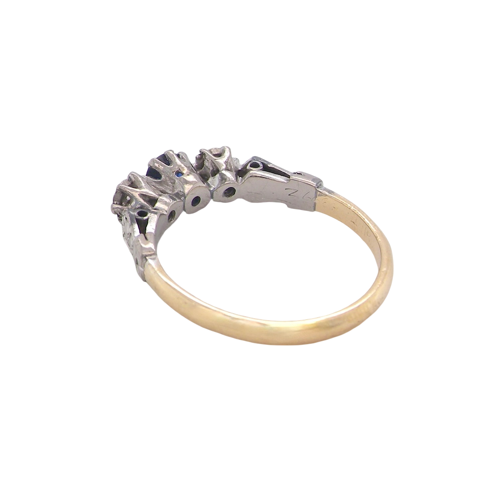 rear An early 20th century engagement ring. The centre stone a dark blue sapphire