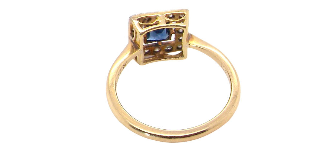 rear An early 20th century square cluster ring. Features a square inky black blue sapphire, 4x4mm (est 0.25 carats) mille grain set.