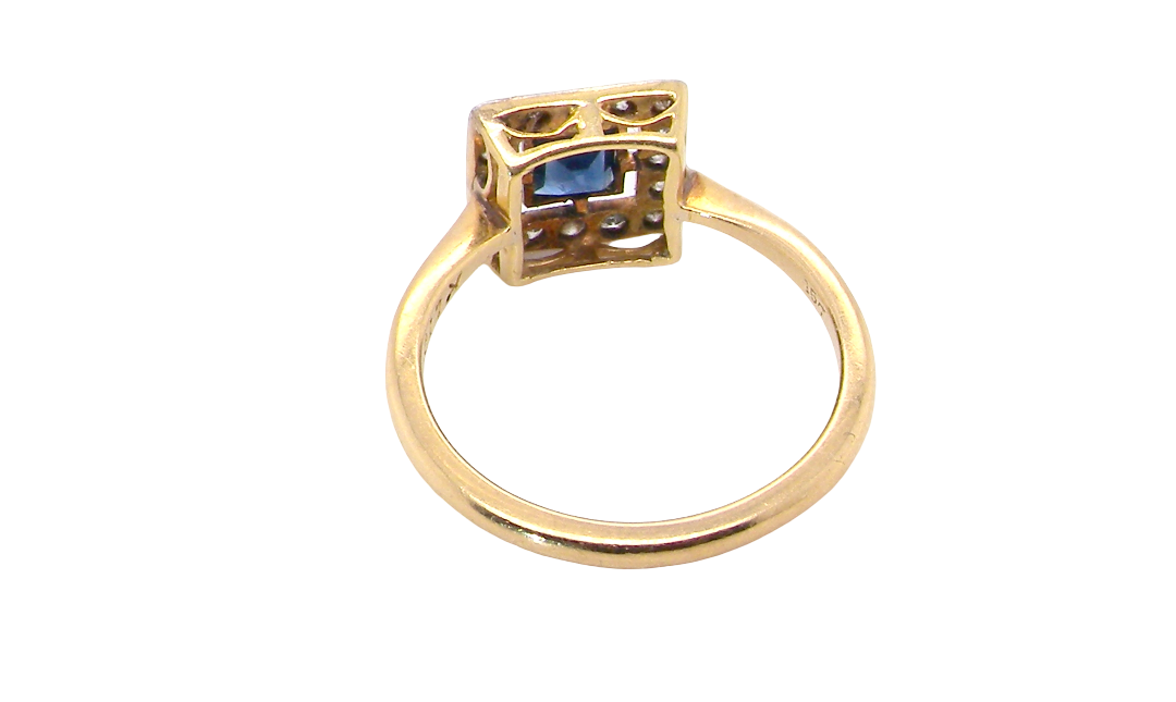 rear An early 20th century square cluster ring. Features a square inky black blue sapphire, 4x4mm (est 0.25 carats) mille grain set.