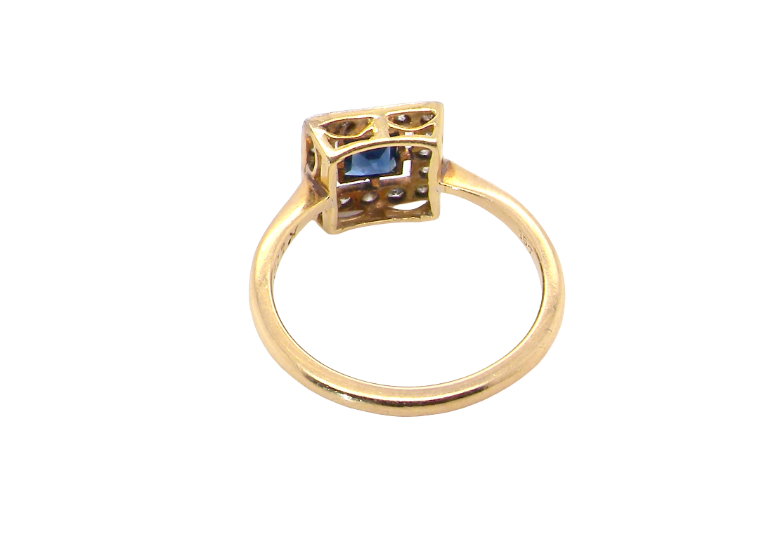 rear An early 20th century square cluster ring. Features a square inky black blue sapphire, 4x4mm (est 0.25 carats) mille grain set.