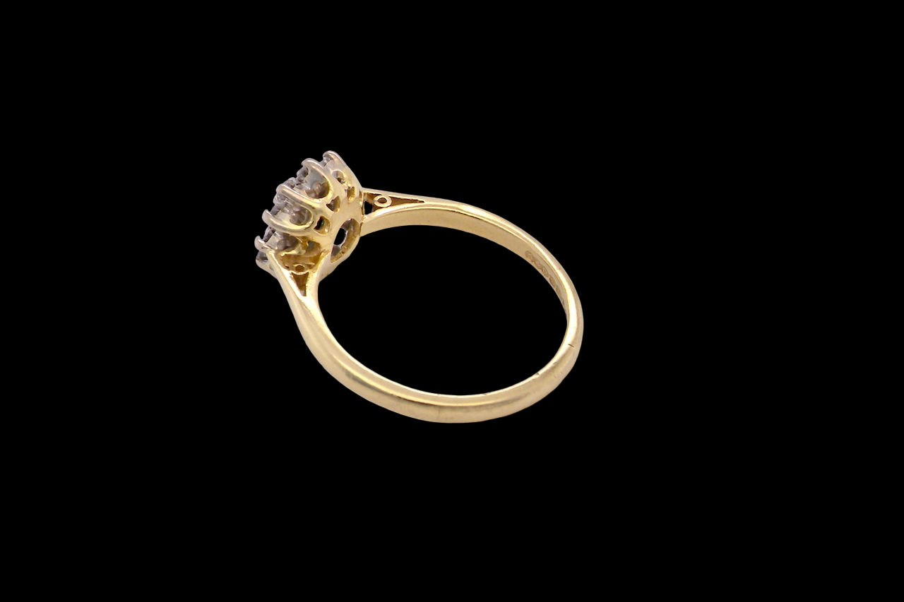 rear An elegant 18 carat gold cluster ring featuring a beautifully proportioned 6 × 4mm green tourmaline