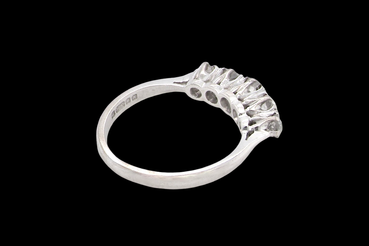 rear An elegant 18 carat white gold five-stone ring set with brilliant-cut white diamonds. The centre diamond measures 3.4mm, flanked by two 3.0mm stones and finished with 2.8mm diamonds at each end, creating a beautifully balanced graduated design.