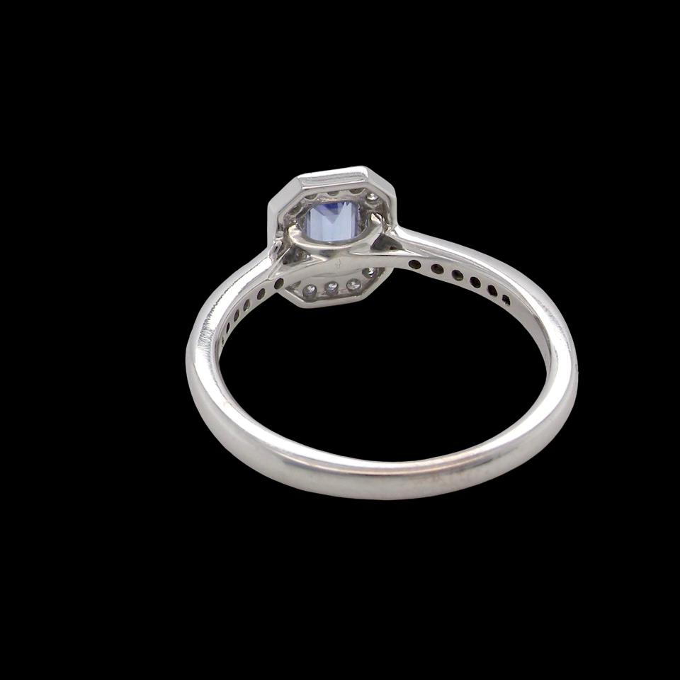 rear An elegant cluster ring that features to the centre a rectangular tanzanite gemstone that measures 6x4mm (est 0.50 carats) AAA colour.