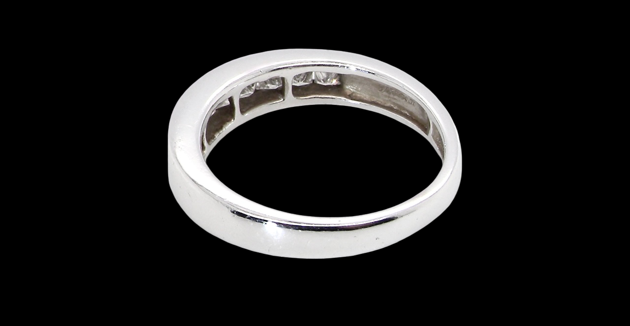 rear An elegant half-hoop eternity ring set with nine princess-cut white diamonds, each measuring approximately 2.5mm, with a total estimated diamond weight of 0.90 carats.