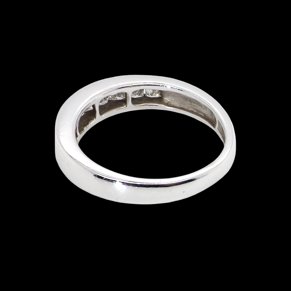 rear An elegant half-hoop eternity ring set with nine princess-cut white diamonds, each measuring approximately 2.5mm, with a total estimated diamond weight of 0.90 carats.