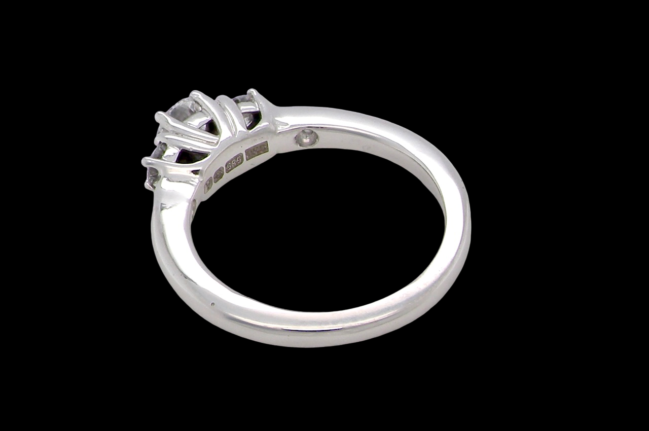rear An elegant trilogy ring set with three brilliant-cut white diamonds,