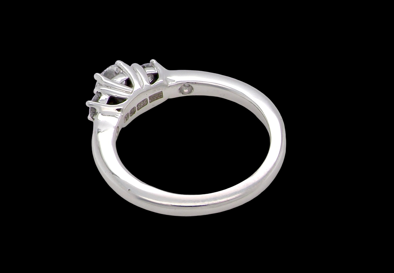 rear An elegant trilogy ring set with three brilliant-cut white diamonds,
