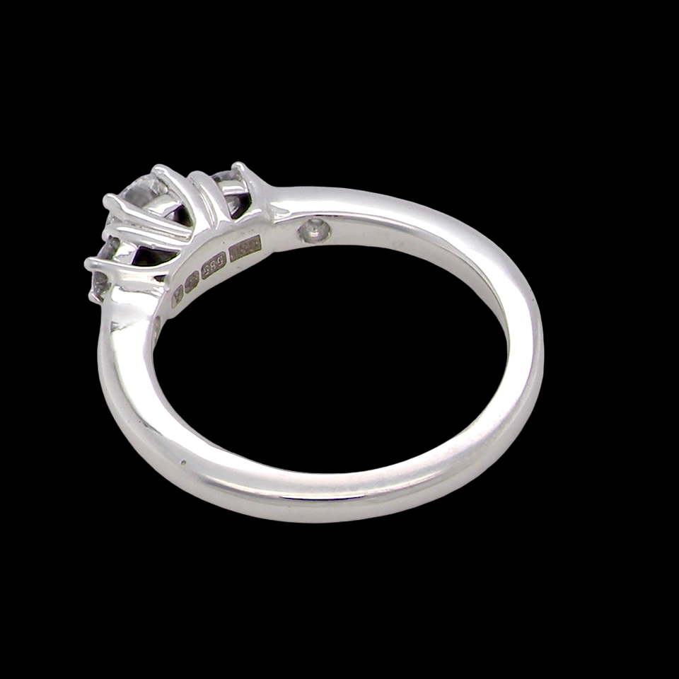 rear An elegant trilogy ring set with three brilliant-cut white diamonds,