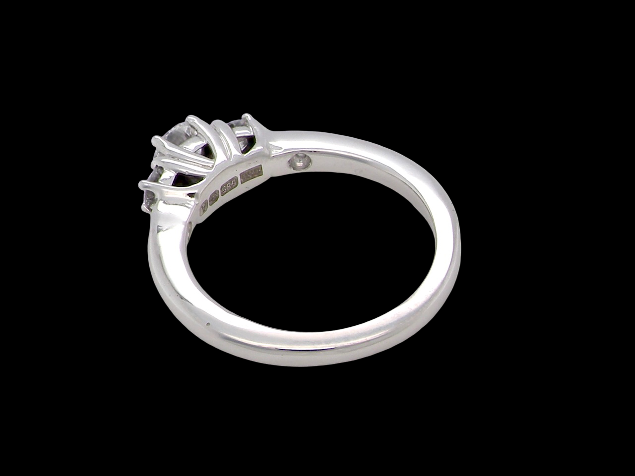 rear An elegant trilogy ring set with three brilliant-cut white diamonds,