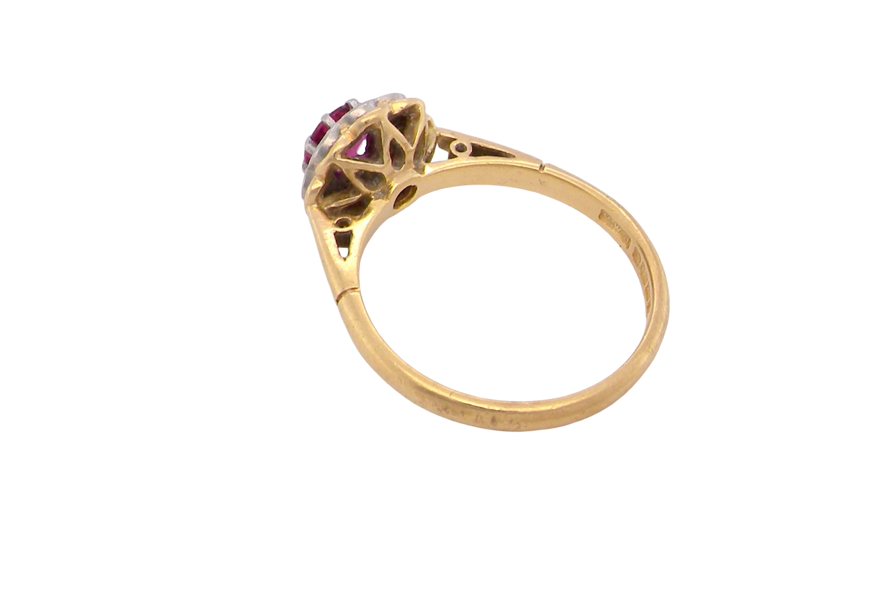 rear An exquisite vintage cluster ring centred around a 5 mm ruby,( 0.50 carats)