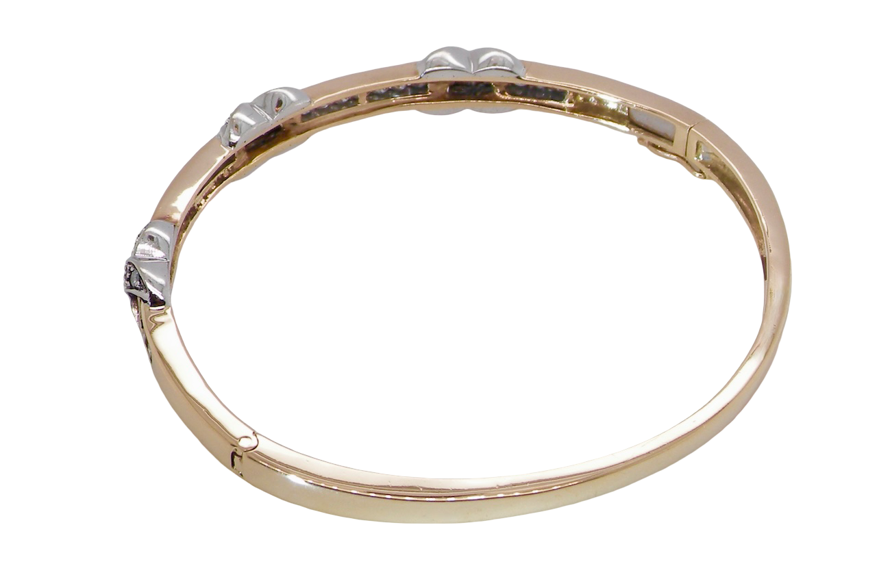 rear An impressive 9 carat gold bangle.
Three 'kiss' shaped sections , each set with nine brilliant cut white diamonds