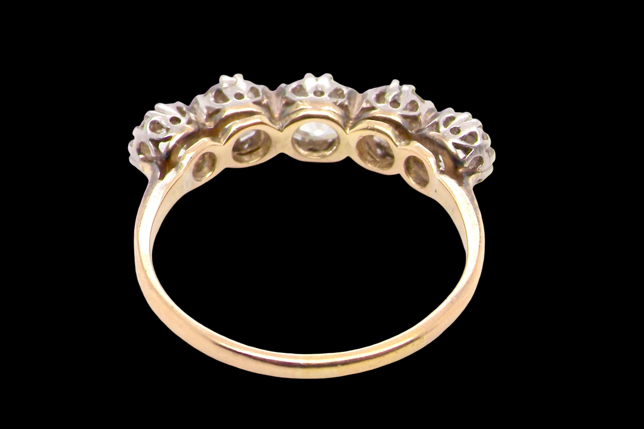 rear An impressive early 20th-century ring set with five old brilliant-cut white diamonds.