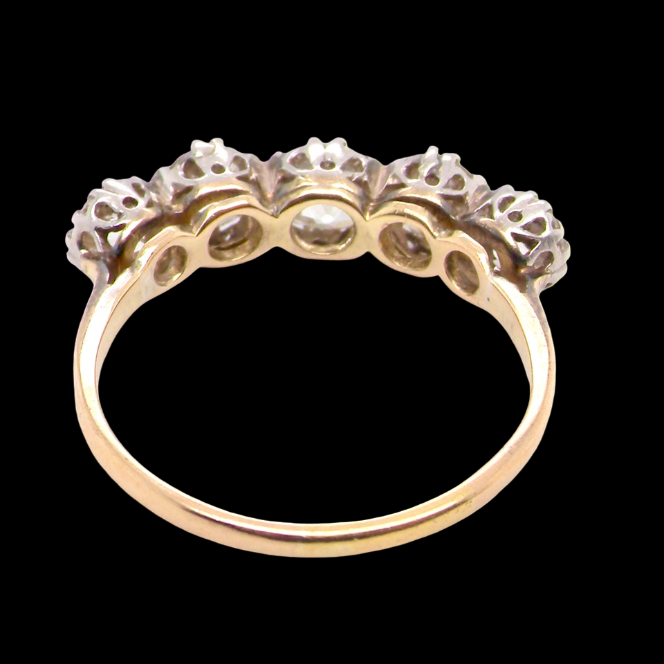rear An impressive early 20th-century ring set with five old brilliant-cut white diamonds.