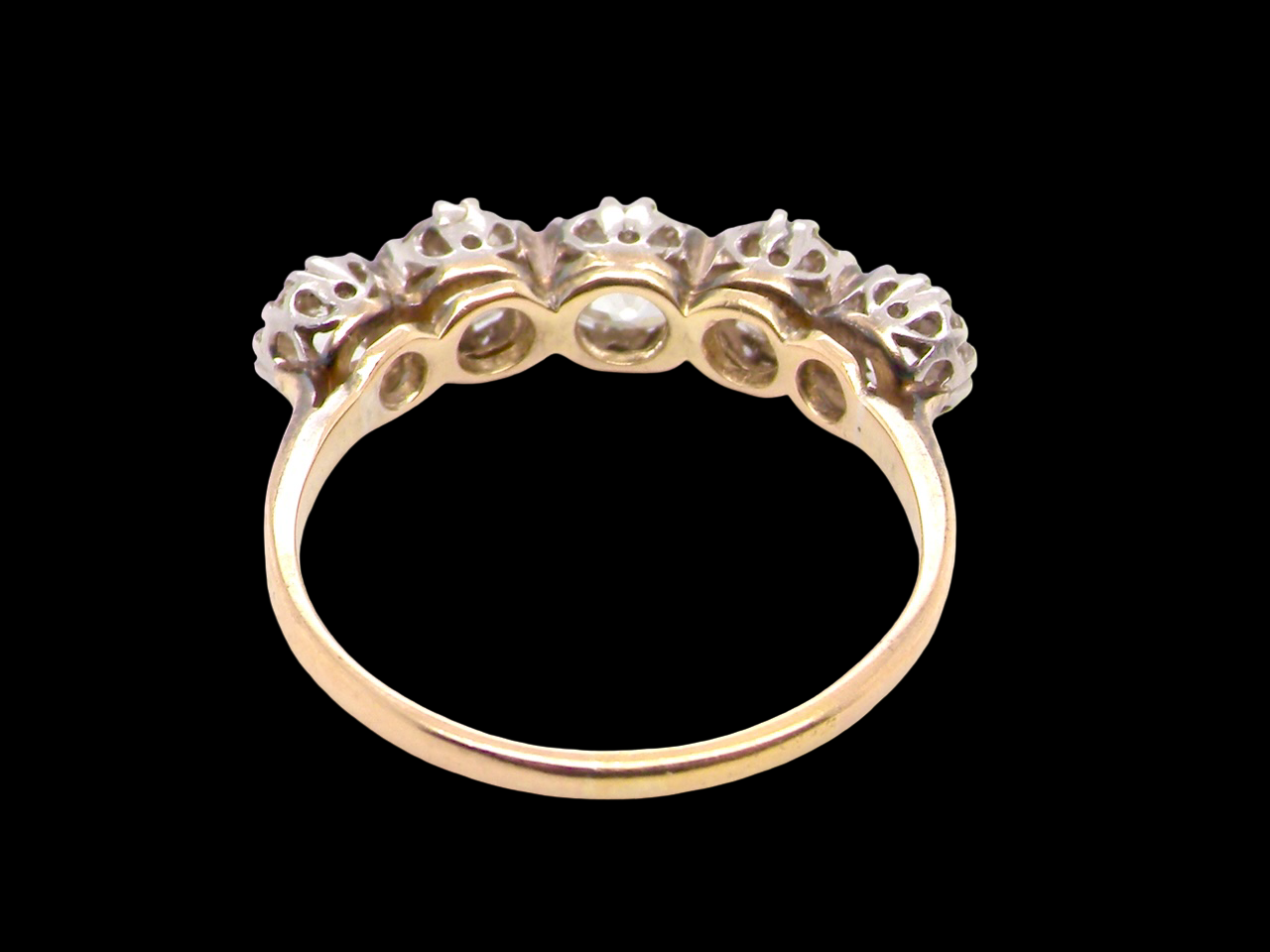 rear An impressive early 20th-century ring set with five old brilliant-cut white diamonds.