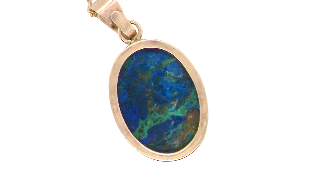 rear An interesting pendant set with an azurmalachite semi precious gem stone. Measures 20x15mm. Gold rim edged setting, with a V shaped bale. (tests as 9 carat gold) 
