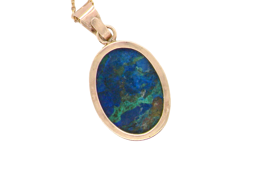 rear An interesting pendant set with an azurmalachite semi precious gem stone. Measures 20x15mm. Gold rim edged setting, with a V shaped bale. (tests as 9 carat gold) 