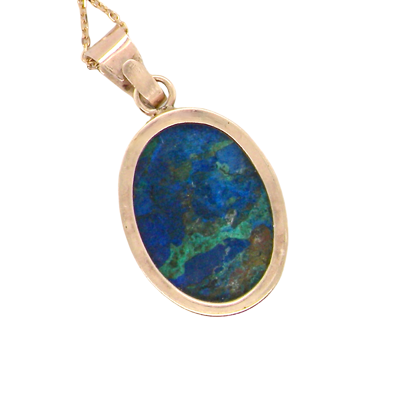 rear An interesting pendant set with an azurmalachite semi precious gem stone. Measures 20x15mm. Gold rim edged setting, with a V shaped bale. (tests as 9 carat gold) 