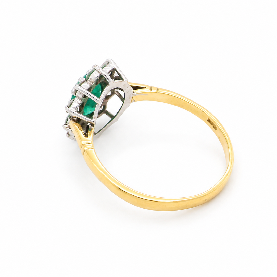 rear Features an oval cut emerald centre stone, vibrant green hues, measures 9x6mm(est 1.75 carats) . Complimented by an outer halo of ten 2.7mm brilliant cut white diamonds (est total 0.60 carats) colour i-j, clarity S.