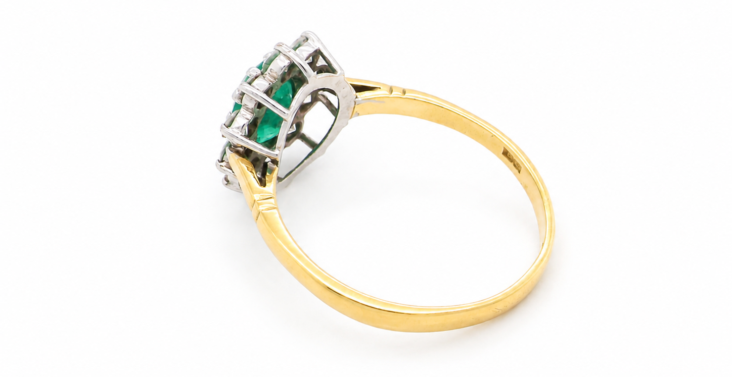 rear Features an oval cut emerald centre stone, vibrant green hues, measures 9x6mm(est 1.75 carats) . Complimented by an outer halo of ten 2.7mm brilliant cut white diamonds (est total 0.60 carats) colour i-j, clarity S.