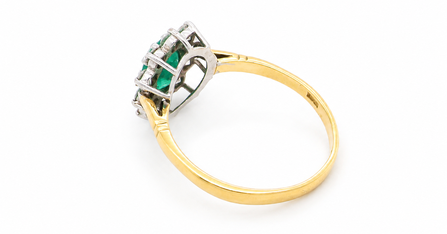 rear Features an oval cut emerald centre stone, vibrant green hues, measures 9x6mm(est 1.75 carats) . Complimented by an outer halo of ten 2.7mm brilliant cut white diamonds (est total 0.60 carats) colour i-j, clarity S.