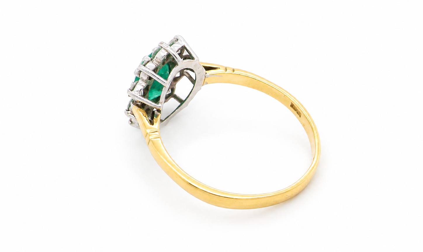 rear Features an oval cut emerald centre stone, vibrant green hues, measures 9x6mm(est 1.75 carats) . Complimented by an outer halo of ten 2.7mm brilliant cut white diamonds (est total 0.60 carats) colour i-j, clarity S.
