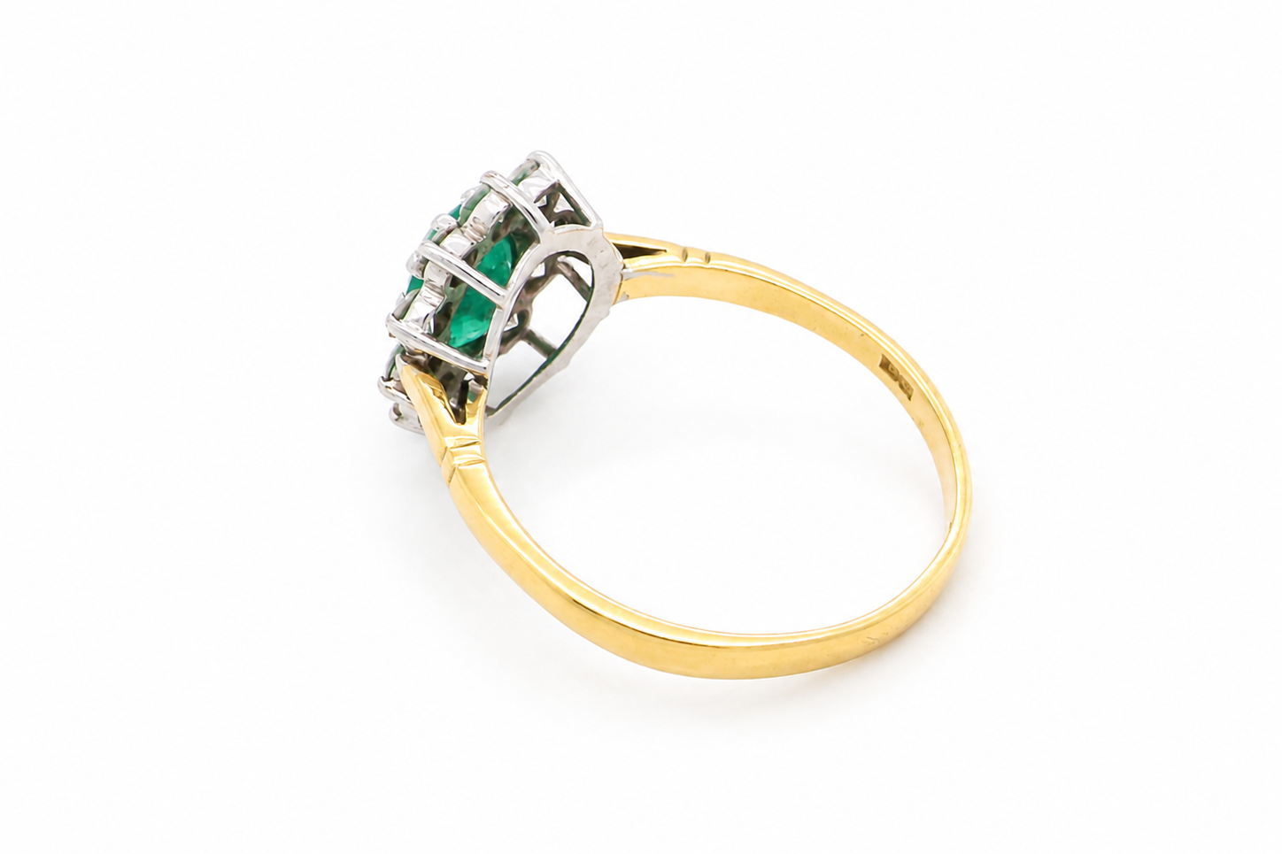 rear Features an oval cut emerald centre stone, vibrant green hues, measures 9x6mm(est 1.75 carats) . Complimented by an outer halo of ten 2.7mm brilliant cut white diamonds (est total 0.60 carats) colour i-j, clarity S.