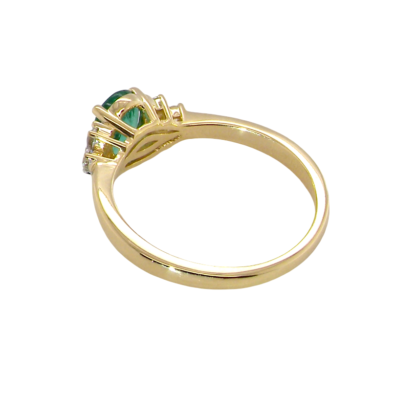 rear Featuring a lovely deep velvety green emerald centre stone, this 18 carat gold ring is enhanced by six brilliant cut white diamonds.