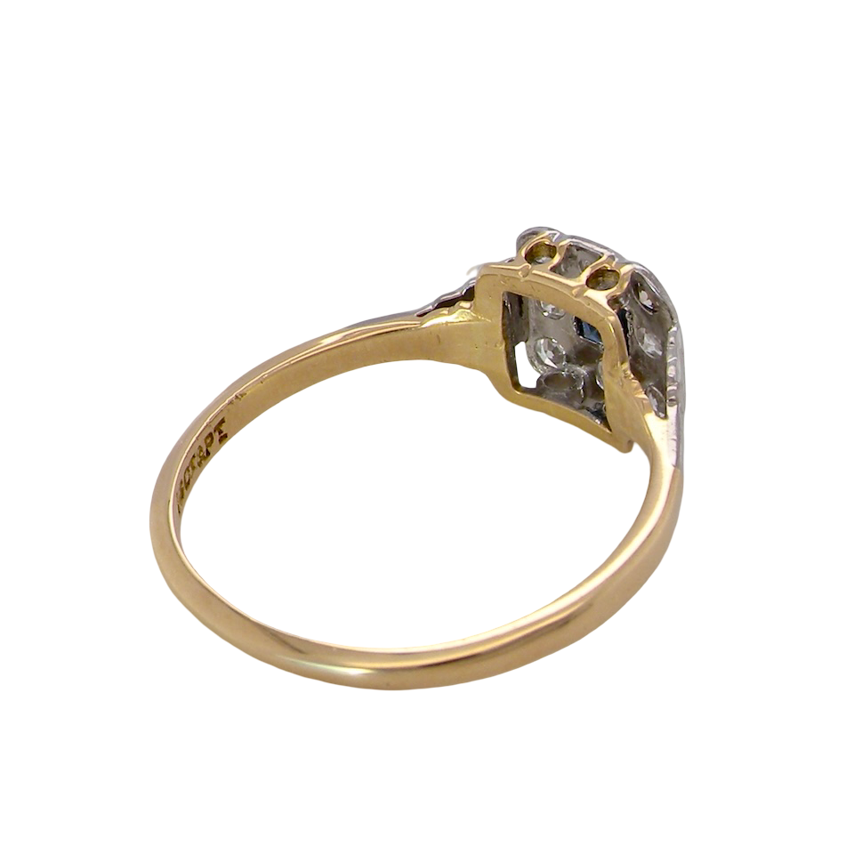 rear antique cluster ring. Features a small square sapphire