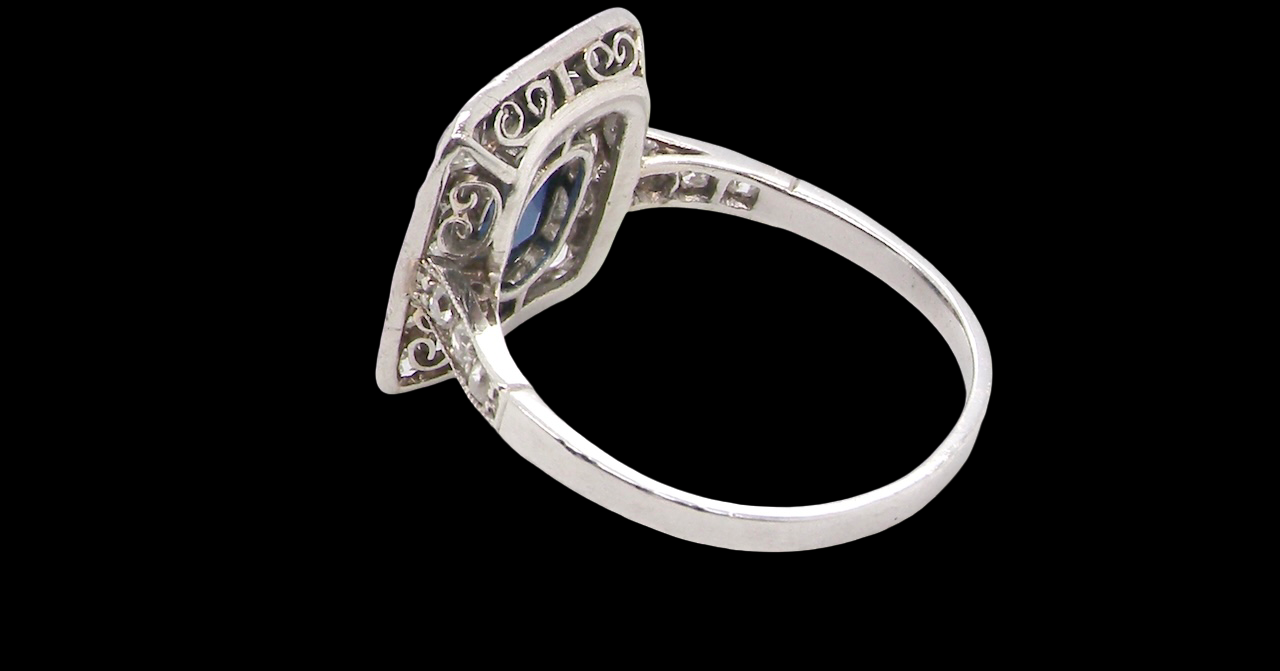 rear beautiful original Art Deco cluster ring featuring a rich, dark blue oval-cut sapphire