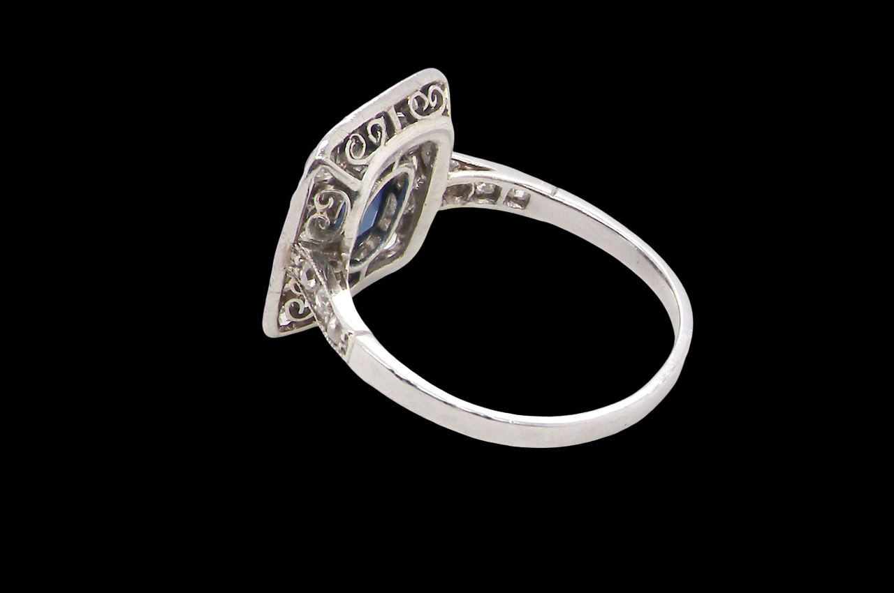 rear beautiful original Art Deco cluster ring featuring a rich, dark blue oval-cut sapphire