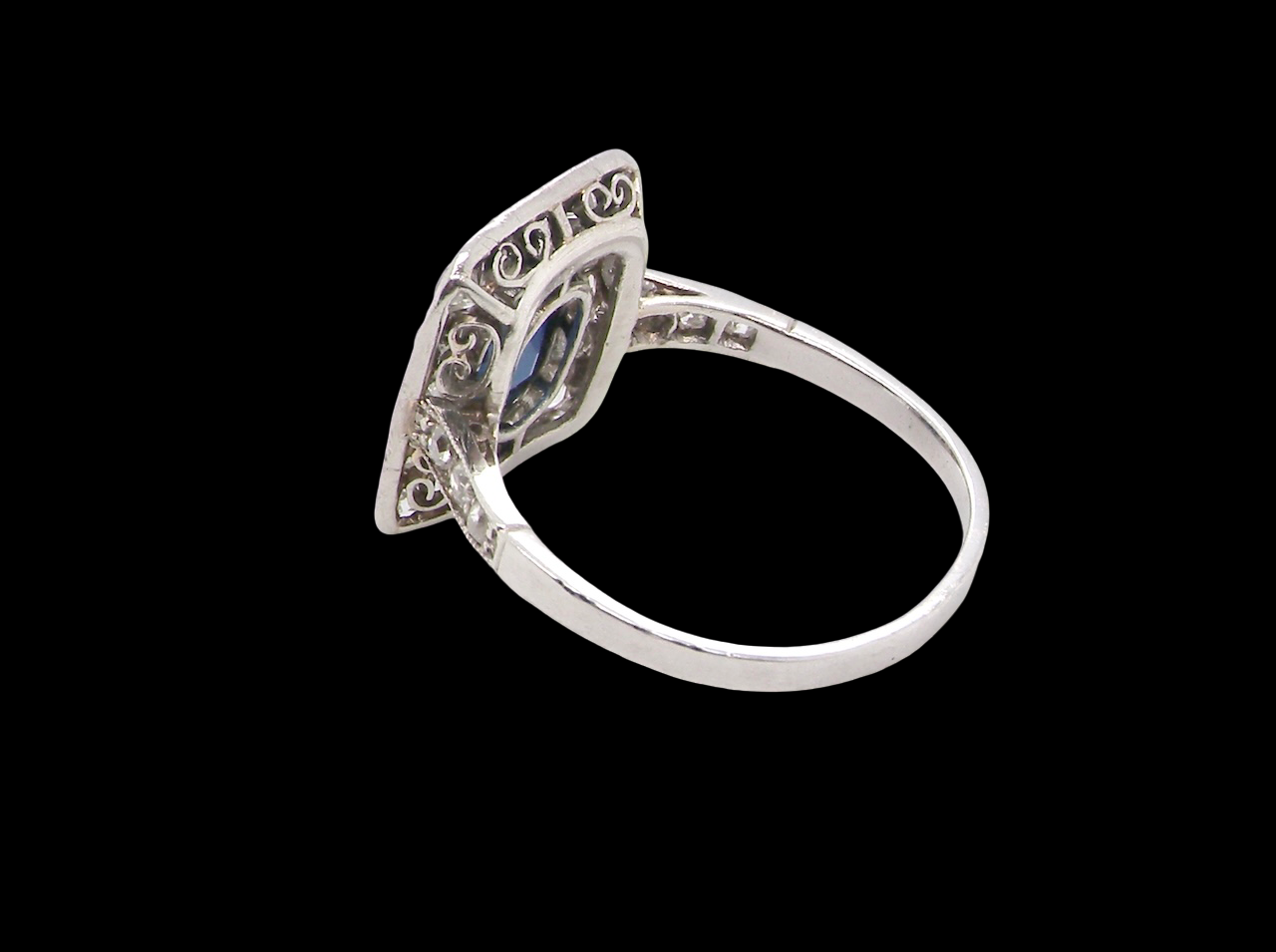 rear beautiful original Art Deco cluster ring featuring a rich, dark blue oval-cut sapphire