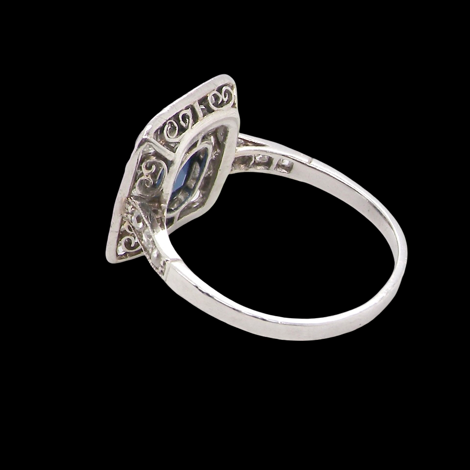 rear beautiful original Art Deco cluster ring featuring a rich, dark blue oval-cut sapphire