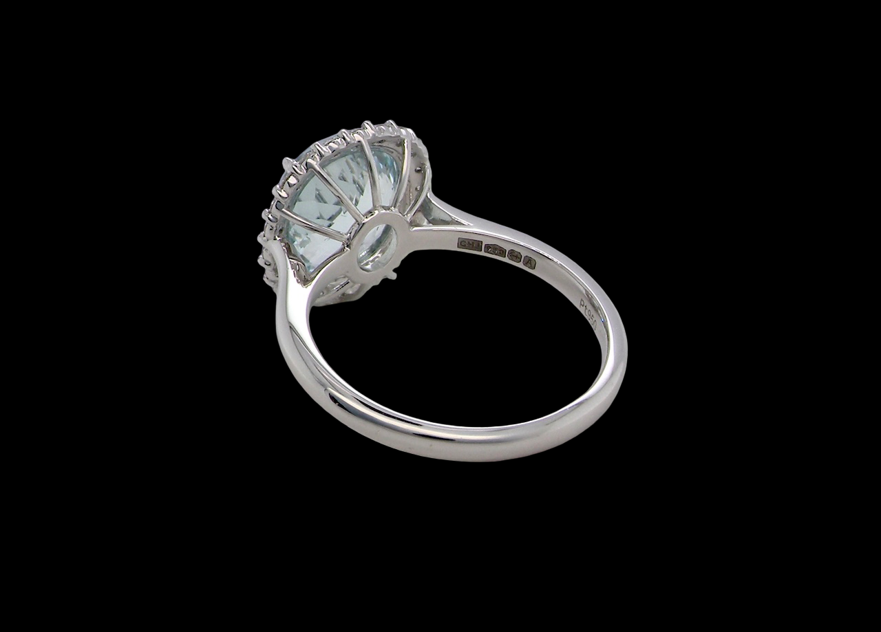 rear elegant cluster ring centred on a beautiful oval aquamarine,