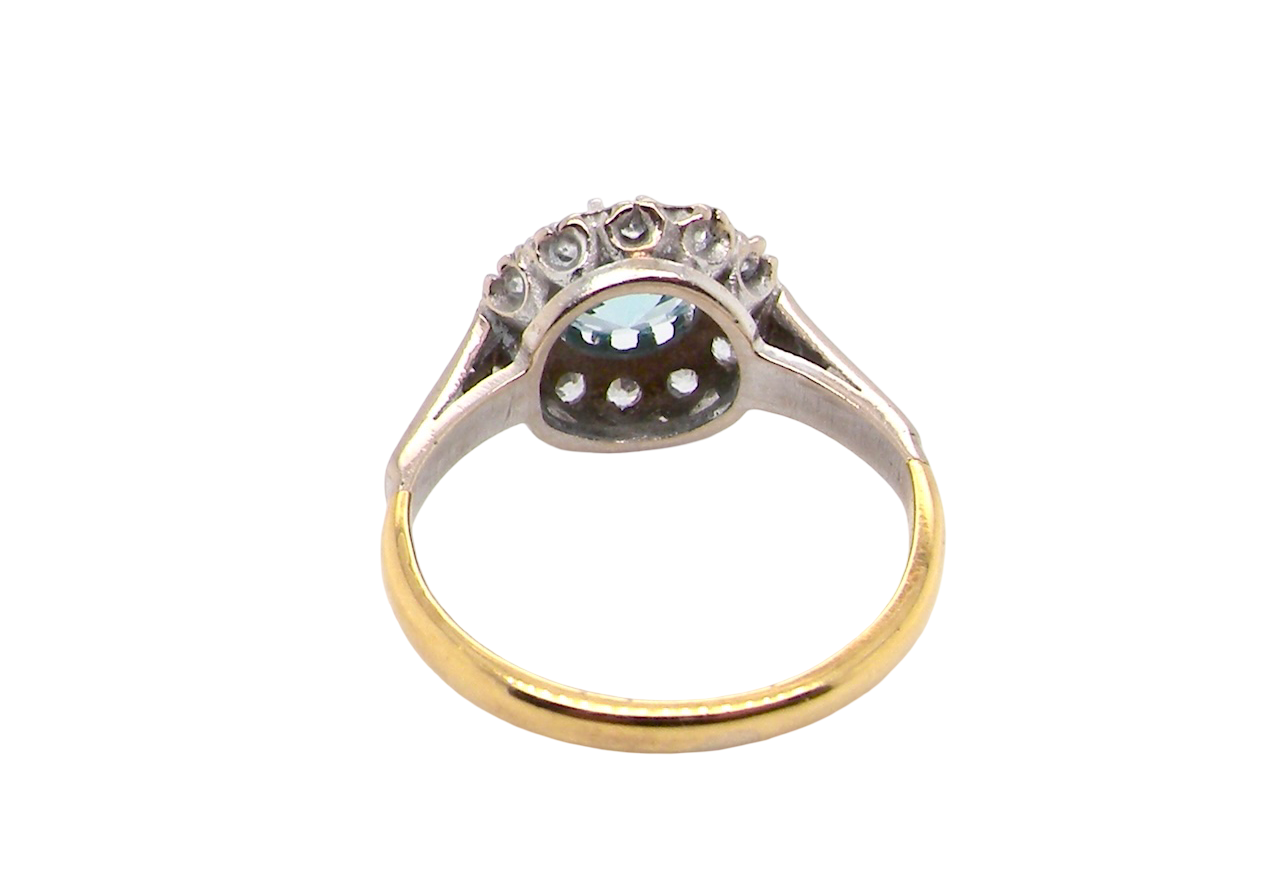 rear fine vintage cluster ring. The centre stone a natural blue zircon, 7mm diameter, bright sparkling refraction to the sky blue hue. 