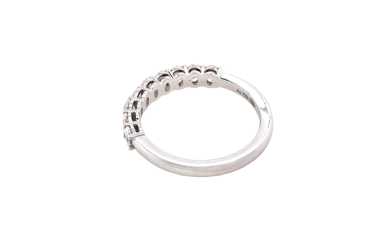 rear gorgeous half-hoop eternity ring set with nine oval brilliant-cut white diamonds.