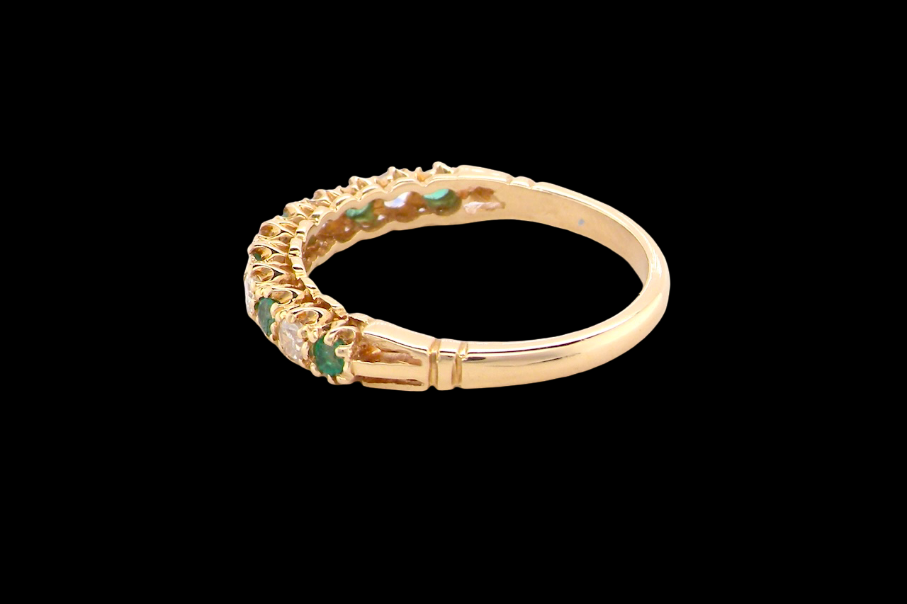 rear half-eternity ring set with alternating emeralds and diamonds.