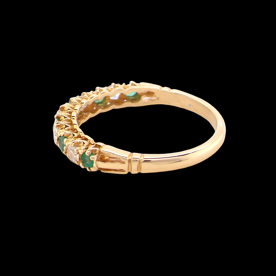 rear half-eternity ring set with alternating emeralds and diamonds.