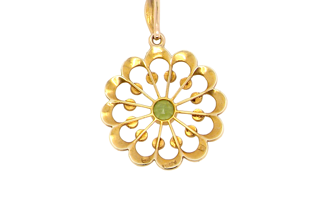 rear pendant from the Edwardian- Age of Elegance-
The centre stone- a round peridot 5mm diameter, mille grain set. A satellite perimeter of twelve seed pearls, each 2.4mm. The outside border is scalloped shaped and each crescent is set with tiny seed pearls.