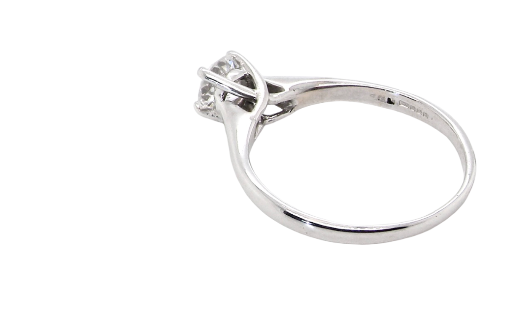 rear solitaire ring containing a fine modern brilliant cut white diamond. Measures 5.4mm (.53 carats)
Colour G-h, clarity Si. Modern feature under setting, depth 6.8mm, weight 2.6grams.