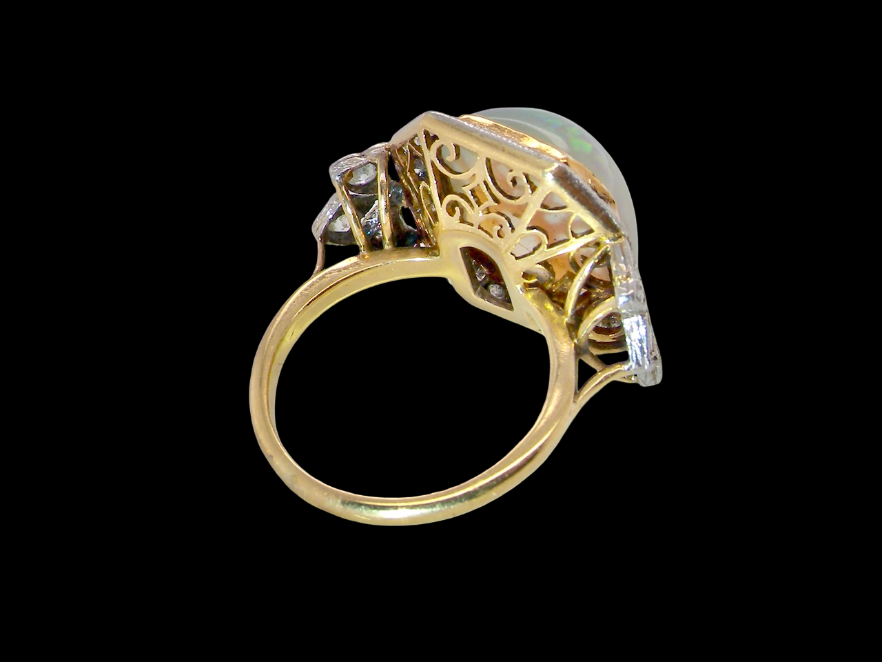 rear view cabouchon cut opal shown is cushion shaped, measures 15x13 (5.78 carats) displaying a mass of vibrant colours, from flashes of fireglow orange, luminous greens, and lavender purples.