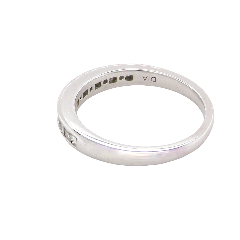 rear An 18 carat white gold half hoop eternity ring. Mixed cuts of white diamonds which consist of seven round brilliant stones, each 2mm diameter and eight baguette cut stones, each 2x1.5mm. Estimated total 0.50 carats.