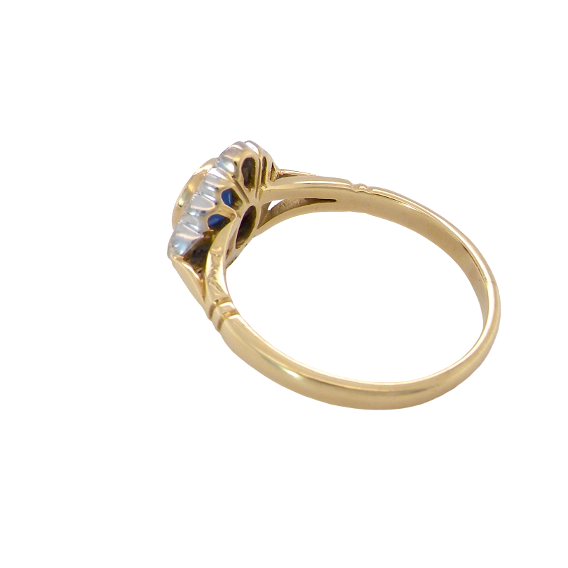 reverse A fine cluster ring featuring to the centre a round dark blue sapphire, 5mm diameter (0.50 carats) mille grain setting.