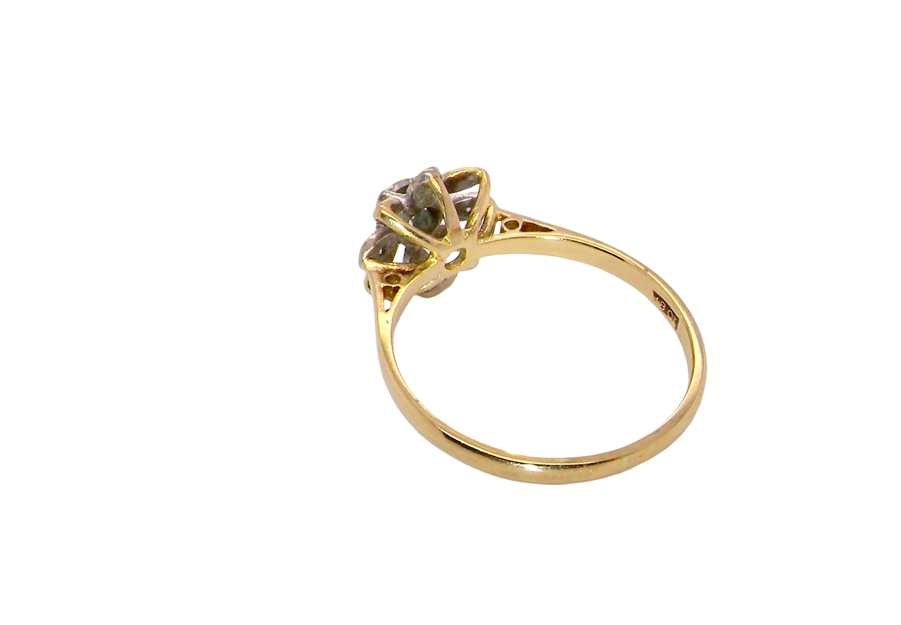 reverse A very pretty cluster ring, a design from the 1950s. Its daisy style was popular during this period, and set with five small white diamonds (total est. 0.05 carats) set into platinum.