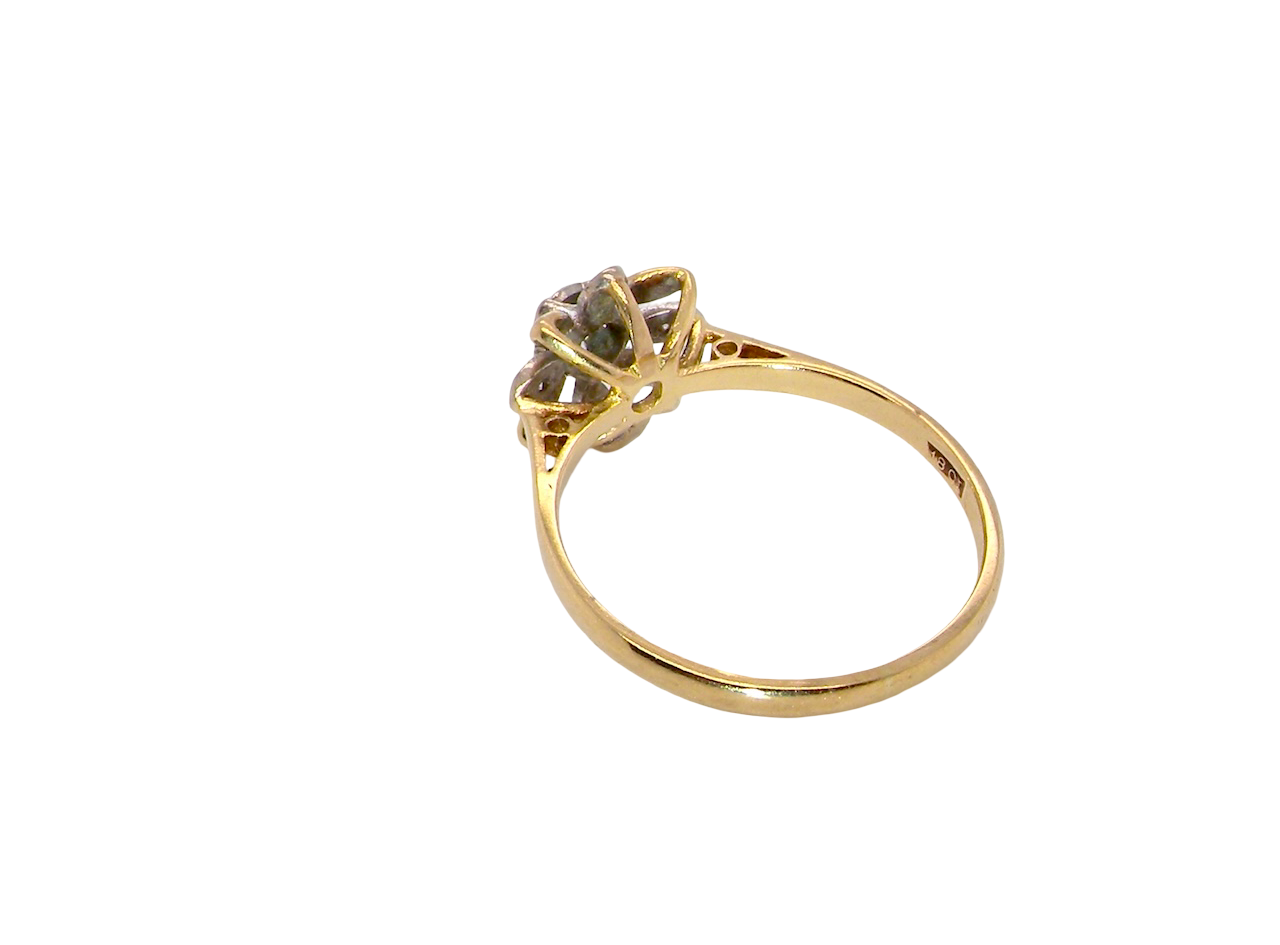 reverse A very pretty cluster ring, a design from the 1950s. Its daisy style was popular during this period, and set with five small white diamonds (total est. 0.05 carats) set into platinum.