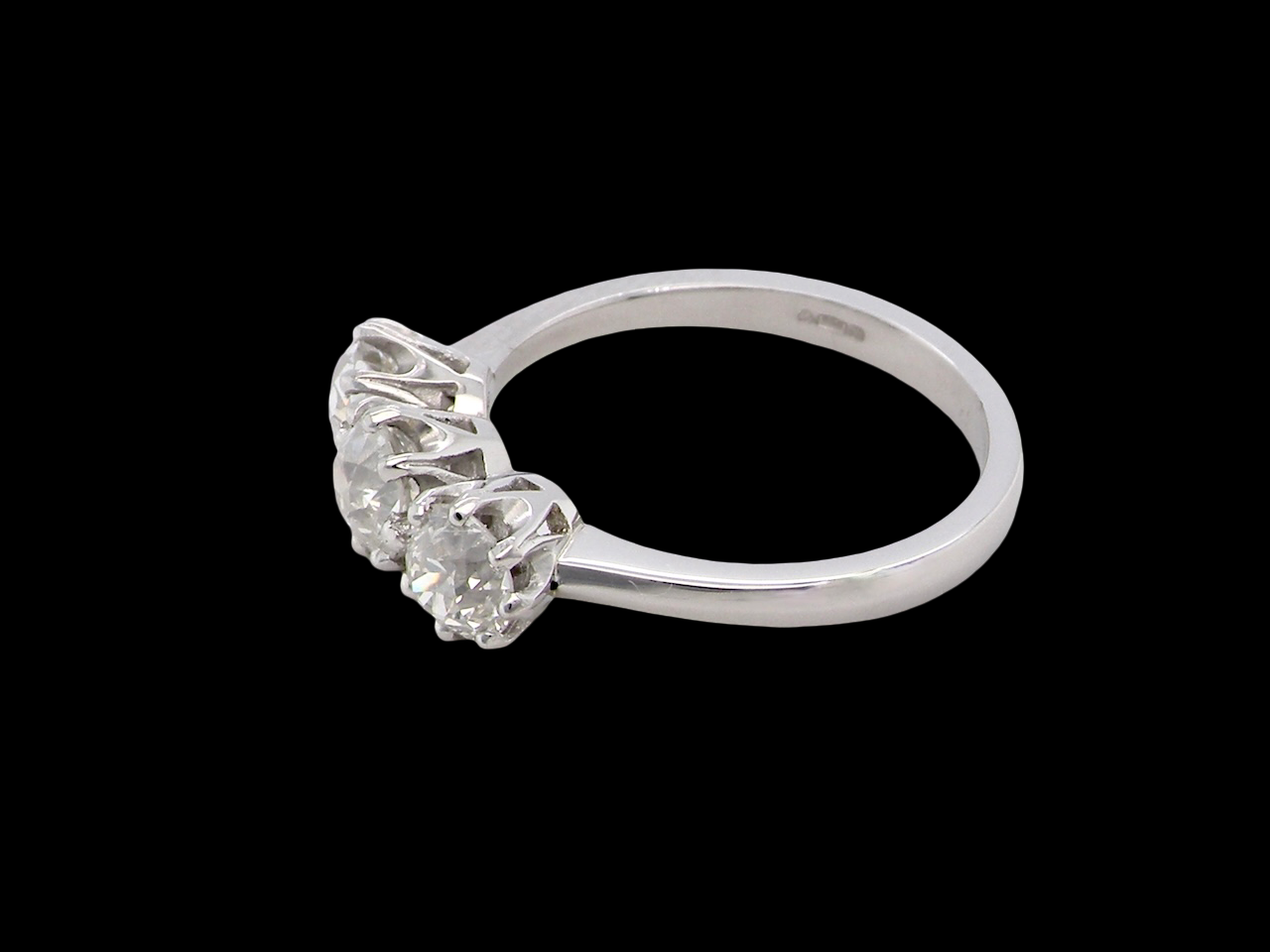 side An ever-popular trilogy three-stone diamond ring, this beautiful example is in near-new condition