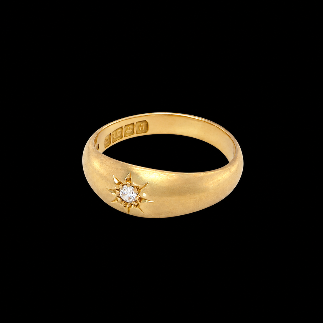 side An 18 carat yellow gold ring, sometimes referred to as a 'gypsy' ring. The diamond measures 2.4mm (0.05 carats) star set.