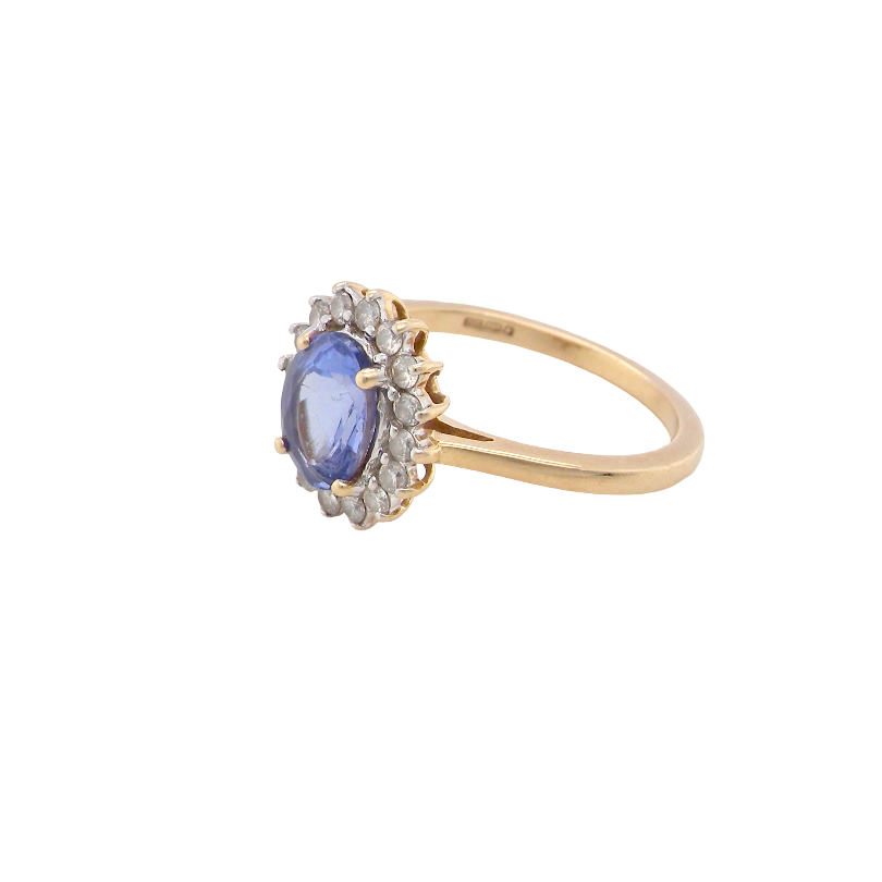side A 14 carat gold cluster ring. Features to the centre an oval cut cornflower blue sapphire, 8x6mm (est 1.25 carats), four claw setting.